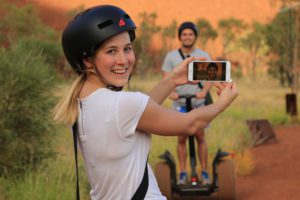 Segway riders take photos of one another at Uluru